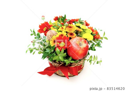 Bouquet of flowers and red apples. Autumn composition in basket on white background 83514620