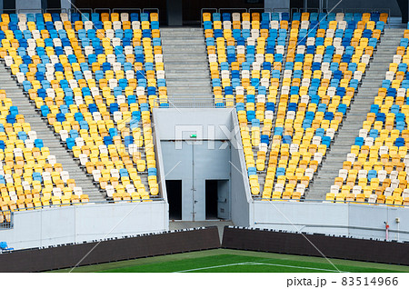 Closeup of yellow and blue seats on stadium 83514966