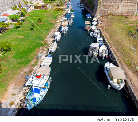 Kerkyra. Canal with fishing boats on a sunny morning. Kerkyra. Canal with fishing boats on a sunny morning. 83515379