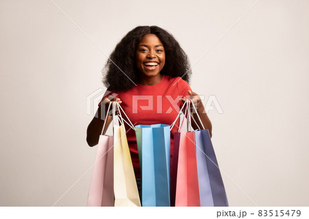 Big Sales. Happy Black Lady Holding Lots Of Bright Paper Shopping Bags 83515479