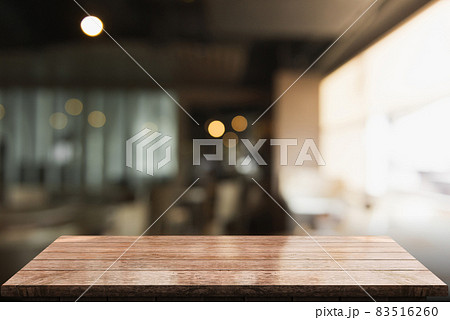 Empty wooden table top with lights bokeh on blur restaurant background. Empty wooden table top with lights bokeh on blur restaurant background. 83516260