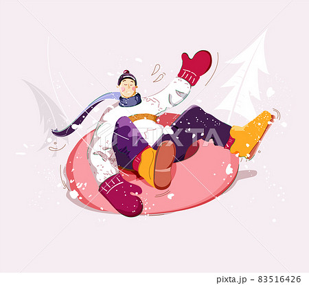 Snow tubing. Boy rides inner tube on snow. Wintertime outdoor activity. 83516426