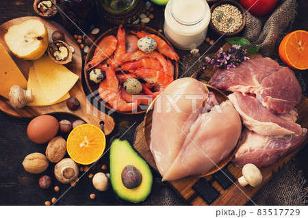 Balanced food background. Healthy eating and diet concept. Protein foods, fruits, juice and vegetables on a rustic wooden background. 83517729