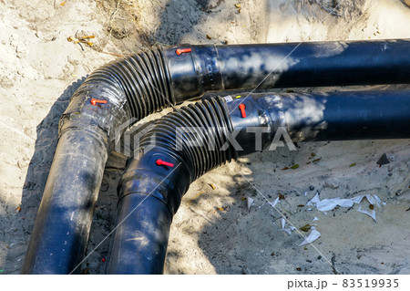 right angle bend of the new heating pipe in a excavated trench 83519935