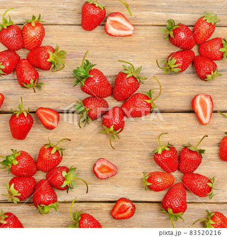 red strawberries on a wooden table . 83520216
