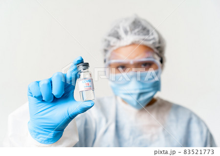 Portrait of asian doctor or nurse in personal protective equipment, female healthcare worker showing covid-19 vaccine, coronavirus vaccination concept 83521773