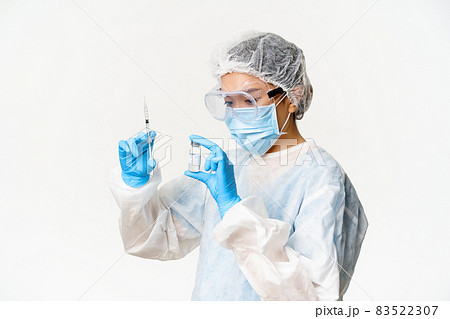 Asian woman doctor or nurse in personal protective equipment, medical mask and gloves, filling syringe with covid-19 vaccine, vaccinating patients, white background Asian woman doctor or nurse in personal protective equipment, medical mask and gloves, filling syringe with covid-19 vaccine, vaccinating patients, white background 83522307