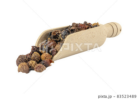 dried rose hip fruit in wooden scoop isolated on white background. Herbs and food ingredients. 83523489