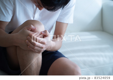 膝を抱える男性の様子 83524059