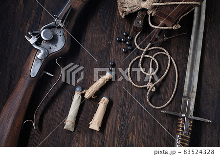 17th century ancient flintlock musket with powder flask and led bullets. 17th century ancient flintlock musket with powder flask and led bullets. 83524328