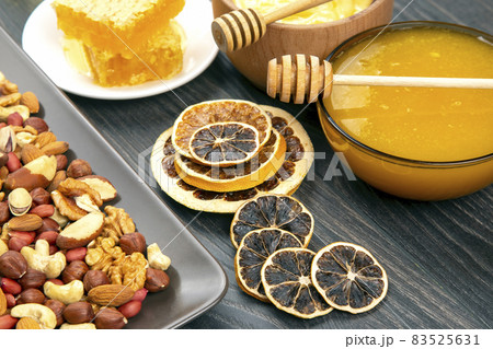 nuts, dried citrus fruits and fresh comb honey. vitamin organic food nuts, dried citrus fruits and fresh comb honey. vitamin organic food 83525631