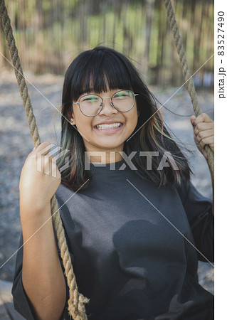 happiness smiling face of asian teenager in open park 83527490