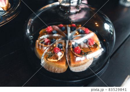 Fruit cakes in a glass cabinet at a coffee shop 83529841