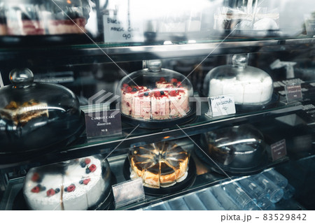 Fruit cakes in a glass cabinet at a coffee shop Fruit cakes in a glass cabinet at a coffee shop 83529842