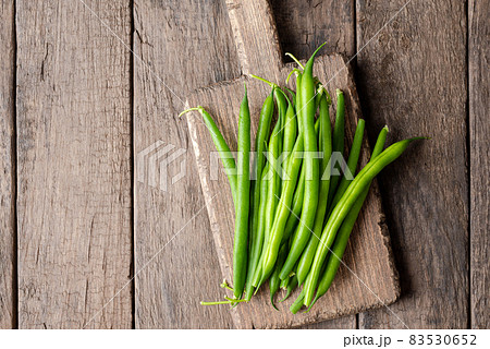 Overhead shot of fresh green bean on wooden table Overhead shot of fresh green bean on wooden table 83530652