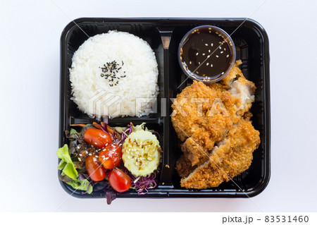 Japanese bento box, Japanese food lunch boxes in plastic packages. Rice with .Japanese Fried Pork Cutlet (Tonkatsu) and Japanese salad with ginger soy dressing. Japanese bento box, Japanese food lunch boxes in plastic packages. Rice with .Japanese Fried Pork Cutlet (Tonkatsu) and Japanese salad with ginger soy dressing. 83531460
