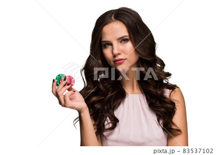 Sexy curly hair brunette posing with chips in her hands, poker concept isolation on white background Sexy curly hair brunette posing with chips in her hands, poker concept isolation on white background 83537102