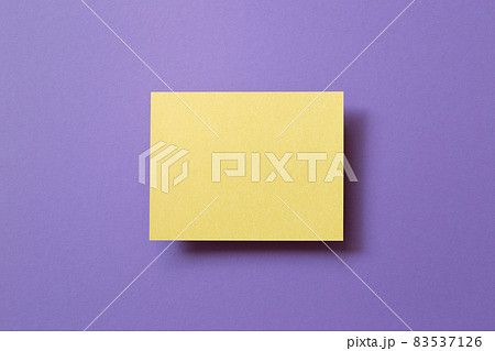 Blank yellow memo pad on purple background. top view, copy space Blank yellow memo pad on purple background. top view, copy space 83537126