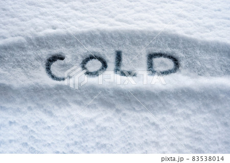 Written white snow cold weather concept. Written word COLD symbol. Snowy winter cold temperature background. Below zero forecast snow concept. Winter cover snow weather conditions. Bad weather warning 83538014