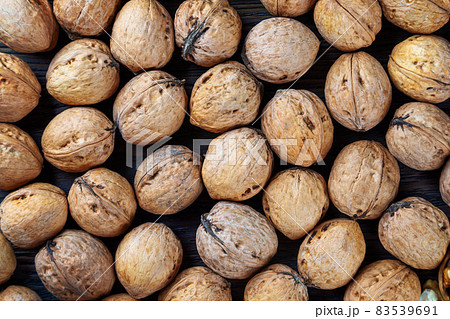 Walnuts on a brown wooden background. Walnuts on a brown wooden background. 83539691