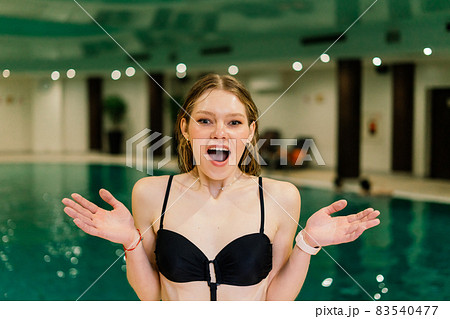 Portrait of beautiful woman in swimwear relaxing in swimming pool spa. 83540477