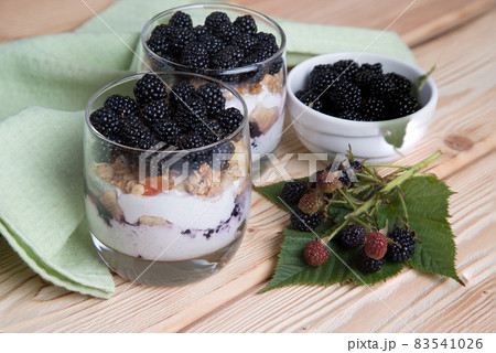 Summer dessert with blackberries, cheesecake in glasses. 83541026