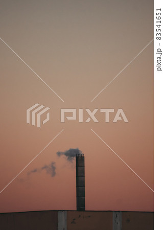 Smokestack against the sunset sky. Pollution of nature and the ozone layer, a symbol of ecology. 83541651