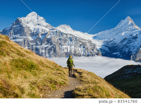 Tourist with a backpack in the mountains. Mountain hiking in the high mountains.  83541760