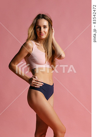 Portrait of young beautiful slim woman in lingerie posing isolated over pink studio background. Natural beauty concept. Portrait of young beautiful slim woman in lingerie posing isolated over pink studio background. Natural beauty concept. 83542472
