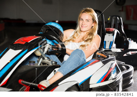 Fine female go-cart racer crossing finish line Fine female go-cart racer crossing finish line 83542841