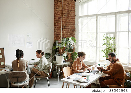 Creative Team Working in Sunlit Office 83542948