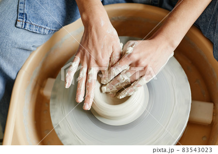 Woman Shaping Pottery on Wheel Close Up Woman Shaping Pottery on Wheel Close Up 83543023