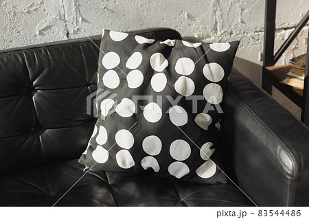 Black and white cushions on a sofa. Modern furniture. Loft interior Black and white cushions on a sofa. Modern furniture. Loft interior 83544486