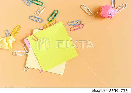 Stack empty sticky post note paper sheet with paper clip on orange background. 83544733