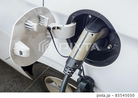 EV charging electric car ecology city vehicle plug. Electric car charger connector for charging electric vehicle socket parking EV charger car recharge battery power. Electric vehicle charging station 83545030