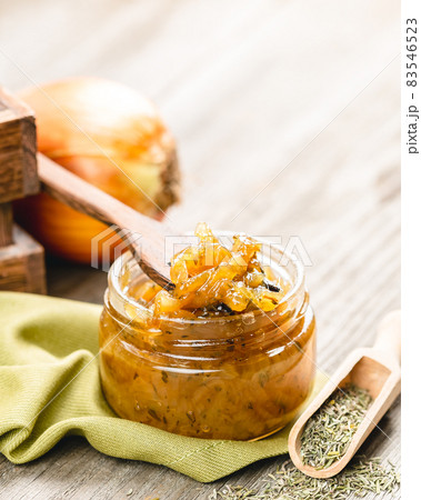 Onion jam in a glass jar on a wooden table Onion jam in a glass jar on a wooden table 83546523