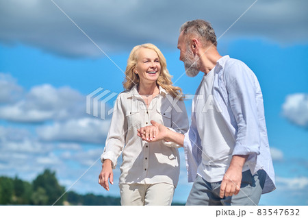 Happy cheerful man and woman walking in nature Happy cheerful man and woman walking in nature 83547632