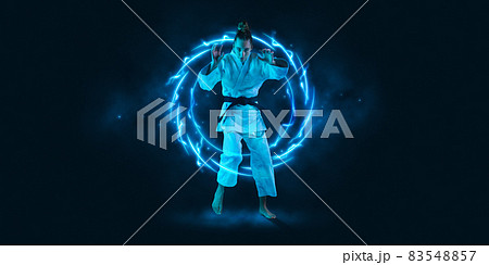 Art collage. Young woman, professional judoka standing isolated on dark background with neoned geometric figure 83548857