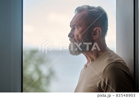 Thoughtful mature man looking into the distance 83548903