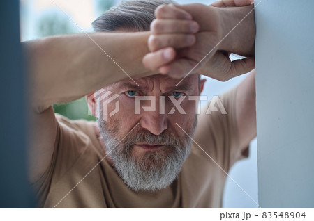 Gloomy blue-eyed Caucasian man pondering over something 83548904