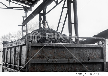 A pile of coking coal in the back of a dump truck. Industrial cargo transportation and transport industy of minerals 83551582