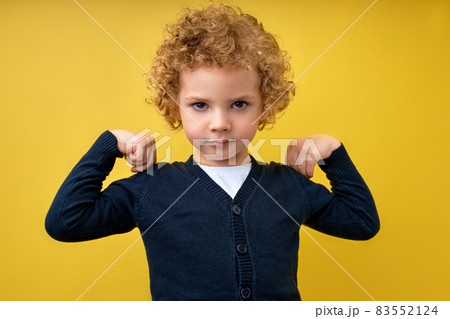 Look at my muscle, I'm strong. Portrait of adorable little boy in T-shirt feeling powerful 83552124
