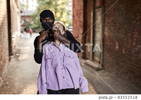 black african aggressive man hold young caucasian woman, violence sex crime 83552518