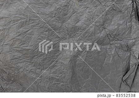 Crumpled black kraft paper for gift wrapping or packaging. Close up, texture background, polution and recycling concept Crumpled black kraft paper for gift wrapping or packaging. Close up, texture background, polution and recycling concept 83552538