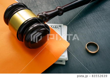 Divorce and alimony concept. Gavel and wedding ring. Divorce and alimony concept. Gavel and wedding ring. 83552639
