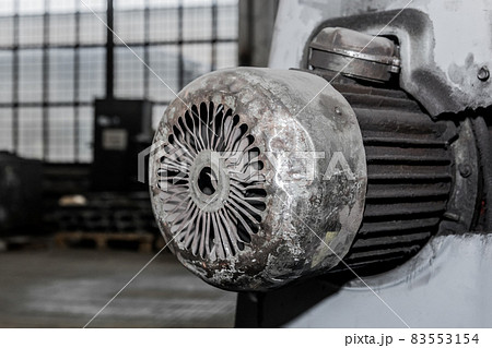 Old flange motor of milling machine industrial equipment in the factory workshop 83553154