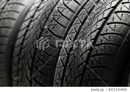 Clean car tyres spinning against dark background Clean car tyres spinning against dark background 83554409
