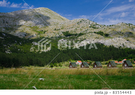Small houses and grass meadow near Negushi village, Montenegro Small houses and grass meadow near Negushi village, Montenegro 83554443