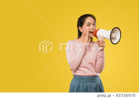 girl with hands beside mouth making announcement using megaphone 83556970