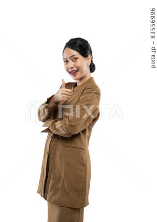 Smiling young civil servant woman standing with thumbs up 83556996